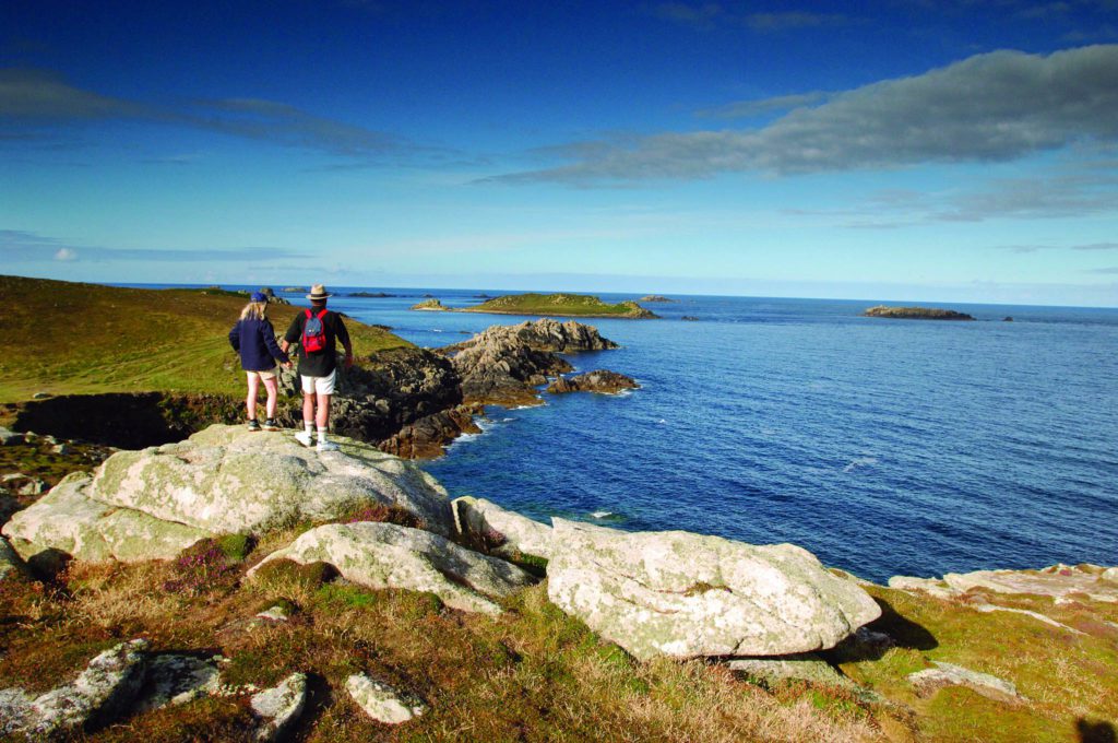 Couple walking the clifftops at Shipman Head on Bryher Isles of Scilly